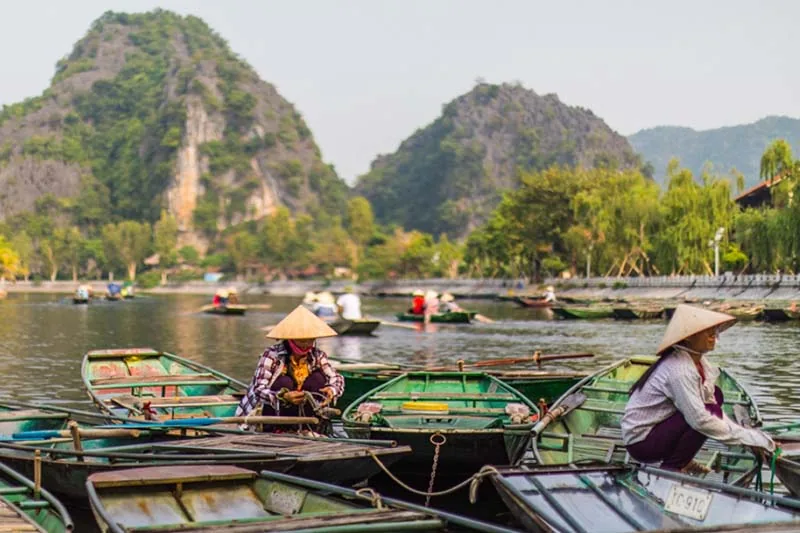 Boat dock with karst mountain backdrop, Ninh Binh